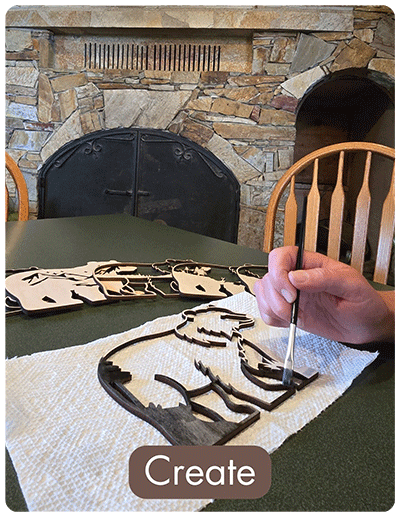 An afternoon of arts and crafts, painting a wood cut out of a girzzly bear.